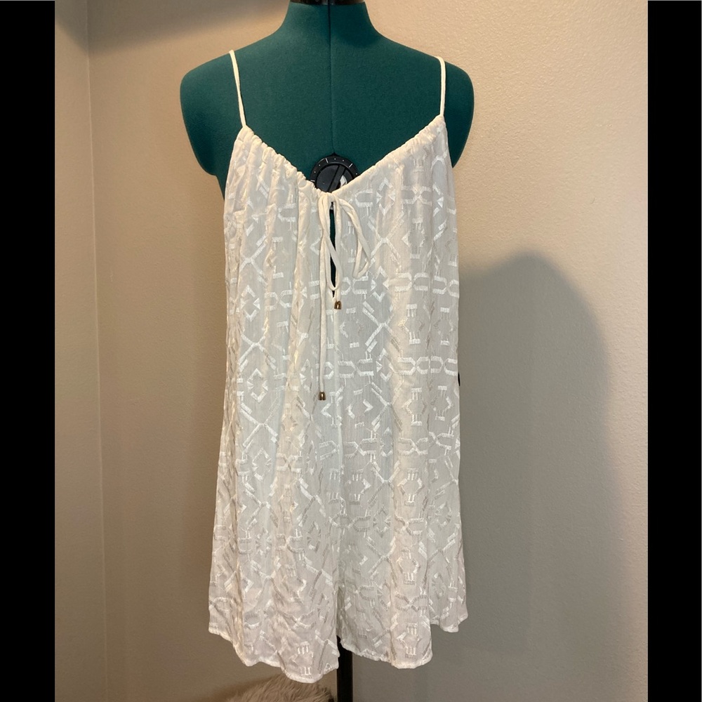 Unknown brand. White adjustable spaghetti strap romper lined.